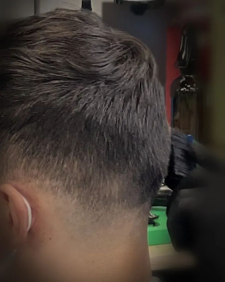 Close view of a fresh fade at the back and side of a client's head